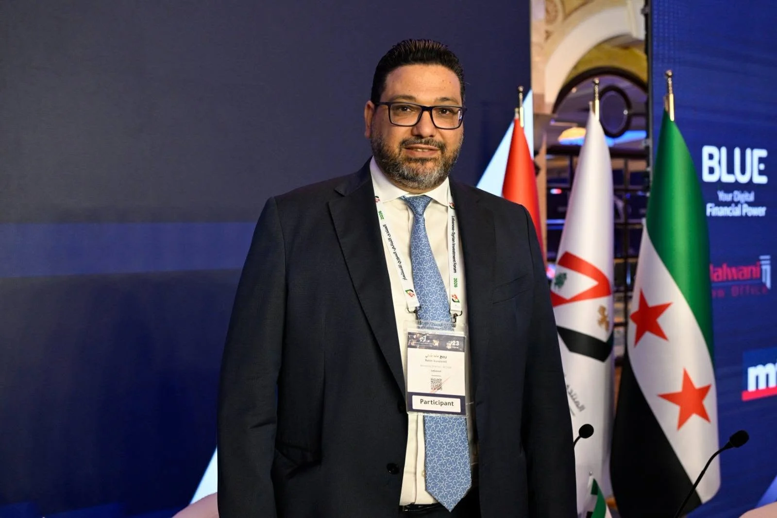 With the Lebanese and Syrian flags at the investment forum